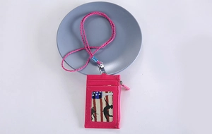 Detail view of pink PU leather card holder with matching braided lanyard and zipper pocket