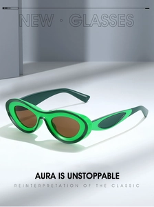Macro shot of stylish green Y2K sunglasses with oval frames and dark brown lenses