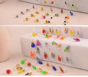 Detailed view of colorful miniature Christmas bulb strings with glossy metallic coating