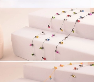 Close-up of miniature colorful electroplated and solid plastic Christmas bulb string beads