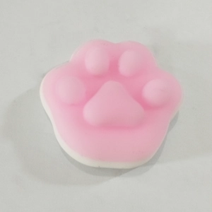 Detailed top view of a soft pink cat paw squeeze toy for stress relief and sensory play