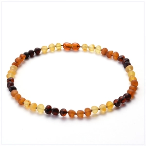 Detailed close-up of natural multicolor amber beaded necklace on a white background