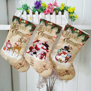 Hanging Christmas stockings with Merry Christmas print and festive elk patterns on white fence