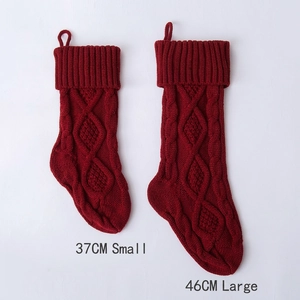 Knitted burgundy Christmas stockings in 37cm small and 46cm large sizes with diamond patterns