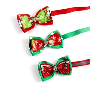 Detail view of festive Christmas pet bow ties with rhinestones and holiday patterns
