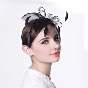 Detail of black mesh headband with peacock feathers and satin ribbon bow for women