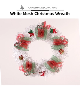 Detail of white mesh Christmas wreath with festive red and green ribbon bows and star charms