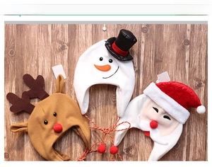 Detail of plush Christmas hats featuring reindeer, snowman, and Santa designs with hanging ropes