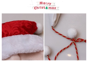 Detail of red velvet Christmas hat with white faux fur trim and gold braided tassels
