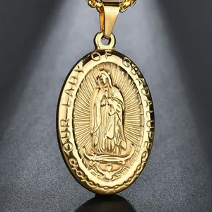 Macro shot of gold oval pendant with Our Lady of Guadalupe relief and fine chain