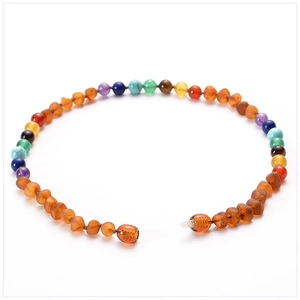 Close-up of colorful amber and gemstone baby necklace with a secure screw clasp