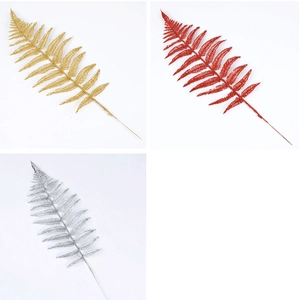 Glittery artificial fern leaves in gold, silver, and red for Christmas tree decoration