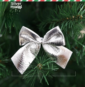 Détail du nœud de Noël argenté 7x6cm avec texture métallique sur le sapin
