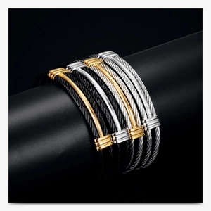 Macro detail of 10mm stainless steel braided cable bracelets in black, gold, and silver