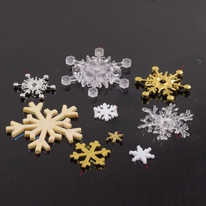 Assorted plastic snowflakes in gold silver and white from 1.3cm to 7cm sizes