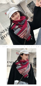 Detail shot of multi-color striped knitted scarf on model in street scene