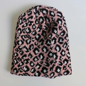Pink and black leopard print knitted beanie for winter warmth and outdoor fashion style
