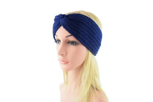 Detail of navy blue knitted headband with cross knot design and cable knit texture