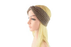 Close-up of beige chunky knit twist headband showing warm textured woolen fabric and knot