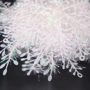 Close-up of white iridescent Christmas branch decorations with shimmering tinsel texture