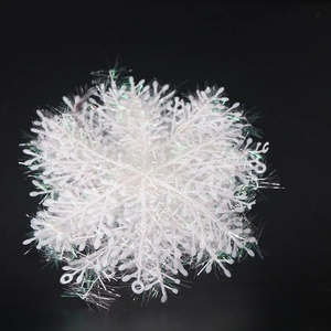Macro detail of white glitter snowflake ornaments with iridescent finish on black background