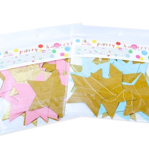 Detail of glitter star garlands in pink, blue and gold for party wall decorations