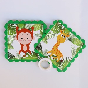 Detail of jungle animal party banner cards with green wavy edges and monkey giraffe prints