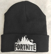 Close-up of Fortnite embroidery and black knit texture on a winter beanie hat