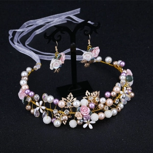 Elegant bridal set with flower hairband and earrings on a professional black display