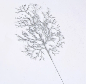 Silver glittered artificial Christmas leaf branch for festive decoration on white backdrop