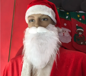 Classic white plush Santa Claus beard and red hat displayed on a mannequin head setup