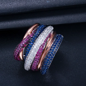 Macro shot of rose gold multi-layered ring with pink, blue, and white zircon micro-pave