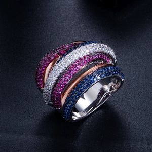 Detailed view of layered silver and rose gold ring with blue and pink pave-set zircons