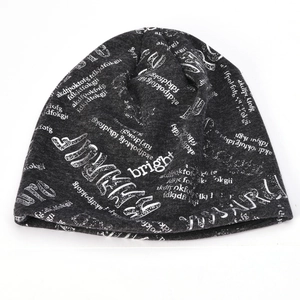 Unisex dark grey knit beanie featuring white graffiti letters and street style print
