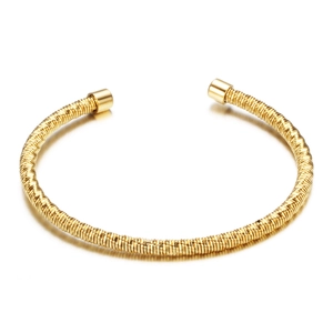 Golden stainless steel cable twisted open bangle bracelet with polished ends on white background