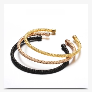 Detailed view of twisted cable stainless steel bangles in gold, rose gold and black colors