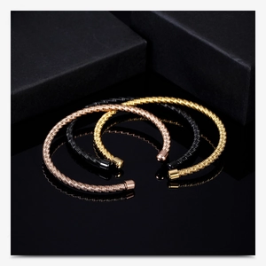 Detailed cable texture of stainless steel open bracelets in rose gold, gold, and black