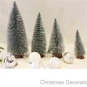 Miniature flocked Christmas trees with wooden bases and LED lights for holiday decor