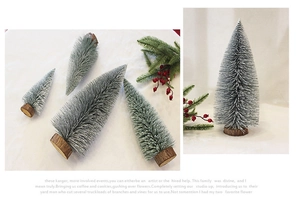 Detail of mini flocked Christmas trees with snow spray effect and wooden round bases