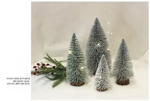 Mini tabletop Christmas tree with flocked snow effect, wooden base and warm LED lights