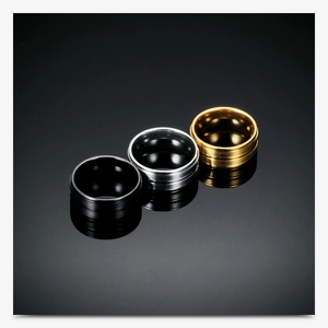 Three 8mm stainless steel rings in black, silver, and gold with double groove details