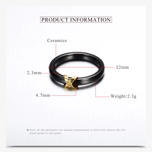 Macro detail of 4.7mm black ceramic ring with golden X-shaped diamond setting