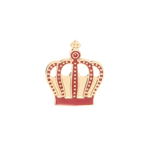 Close-up of a crown brooch with gold alloy finish and red enamel cross detail