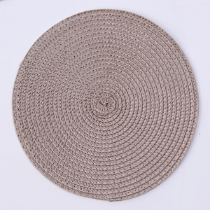 Close-up of the woven texture and circular design of this light brown PP placemat