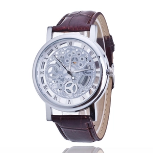 Detail of mechanical skeleton watch with silver Roman numerals and brown leather strap