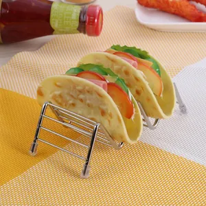 Stainless steel taco holder with non-slip feet on a yellow checkered tablecloth