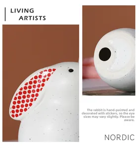 Detail of Nordic ceramic rabbit figurine with blue speckles and hand-painted red ears