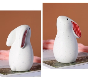 Close-up of modern ceramic rabbit figurines with plaid ear detail and dotted pattern