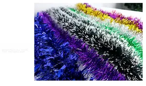 Colorful Christmas tinsel garlands in blue, purple, silver, green, yellow, and pink colors