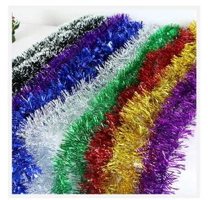 Colorful metallic tinsel garlands in gold, silver, red, and green for Christmas decor